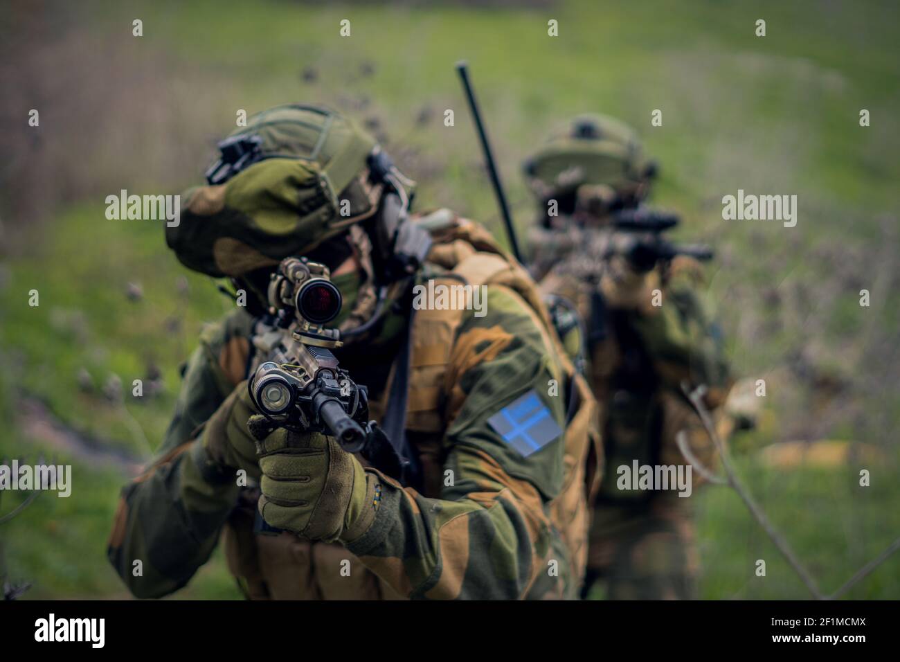 An assault rifle in the hands of the aiming special forces soldier Stock Photo