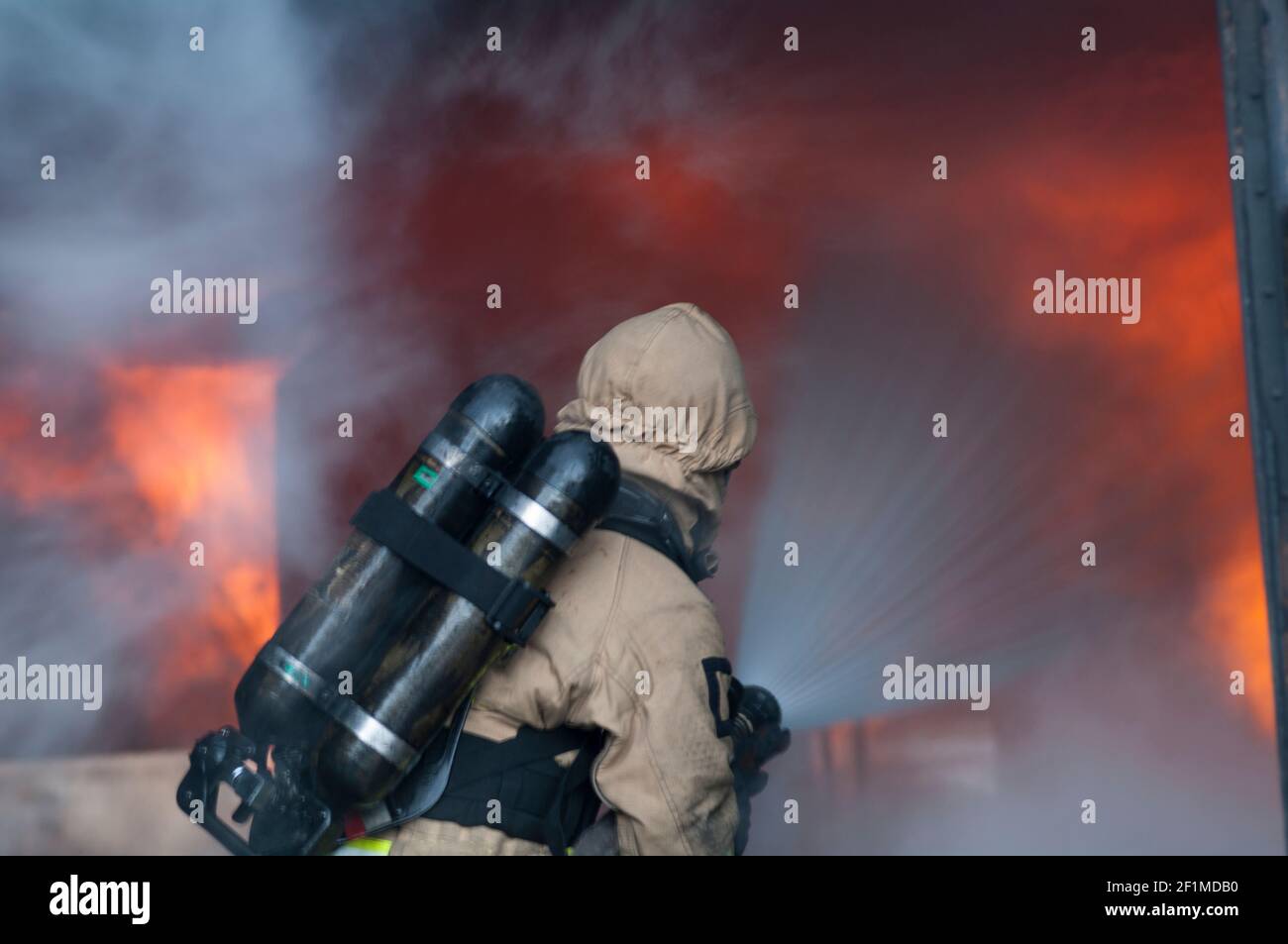 Fireman holding water hose hi-res stock photography and images - Alamy