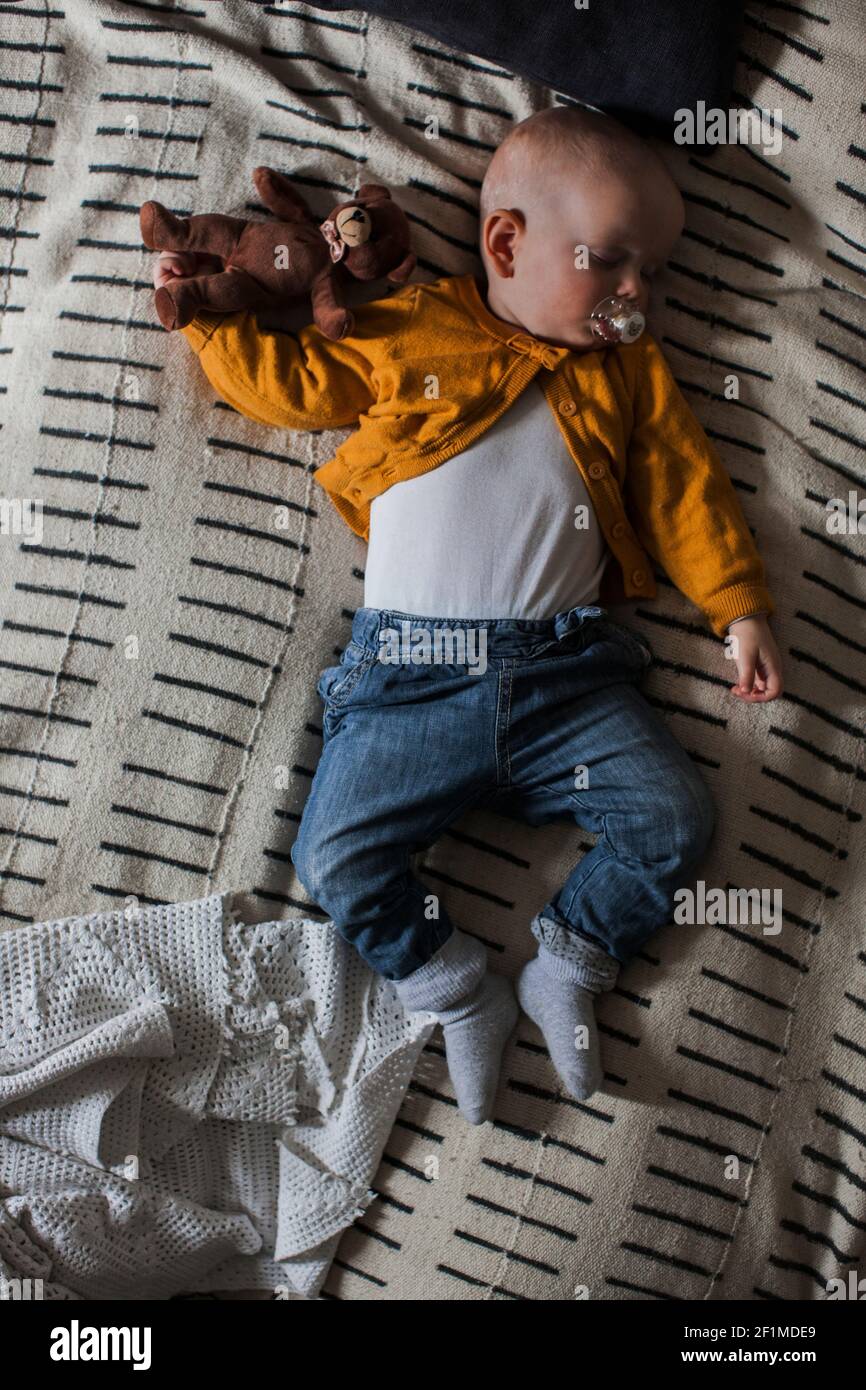 Baby boy sleeping with teddy bear Stock Photo