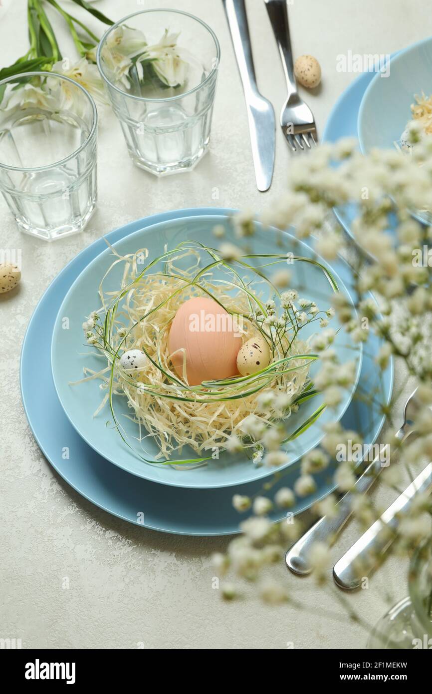 Happy Easter table setting with eggs on white textured table Stock Photo