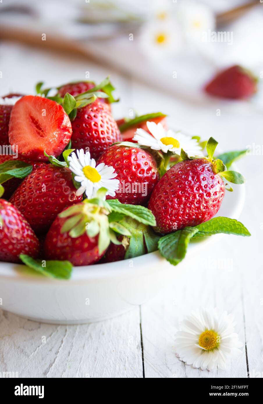 Fresh strawberries in bowl with leaves and flowers Stock Photo - Alamy