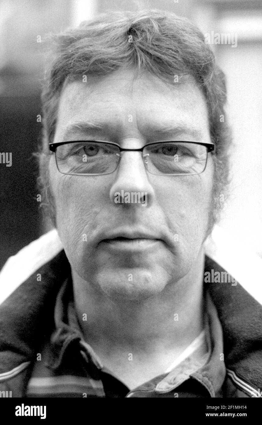Tilburg, Netherlands. Portrait in Black & White of a mature adult male, names Guido Koppes wearing glasses. Stock Photo