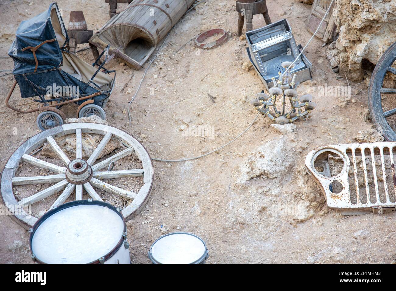 Various old junk scattered in the sand. Fragment of design of popular Farsha cafe in Sharm El Sheikh, Egypt. Stock Photo