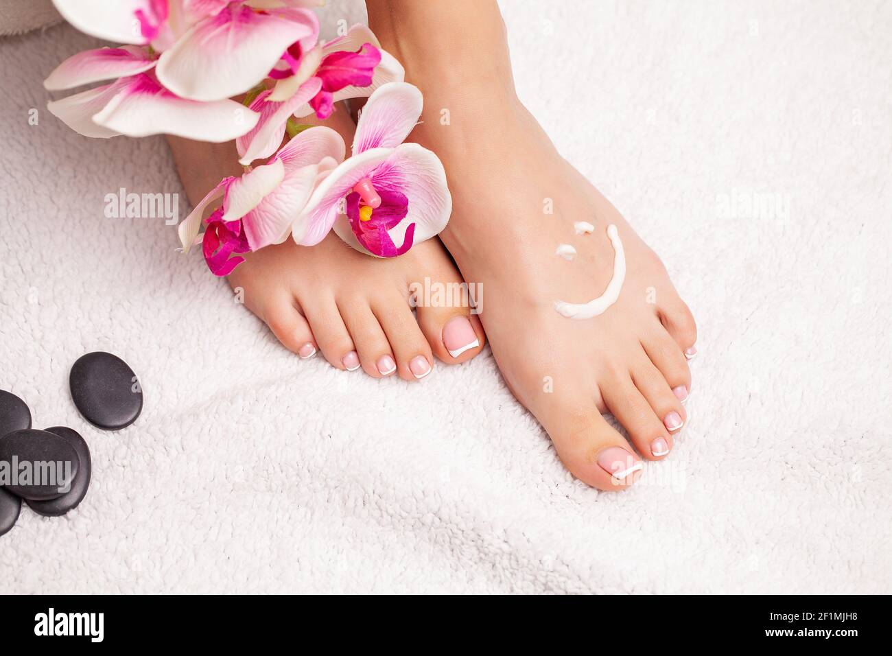 Closeup photo of a female feet at spa salon on pedicure procedure Stock