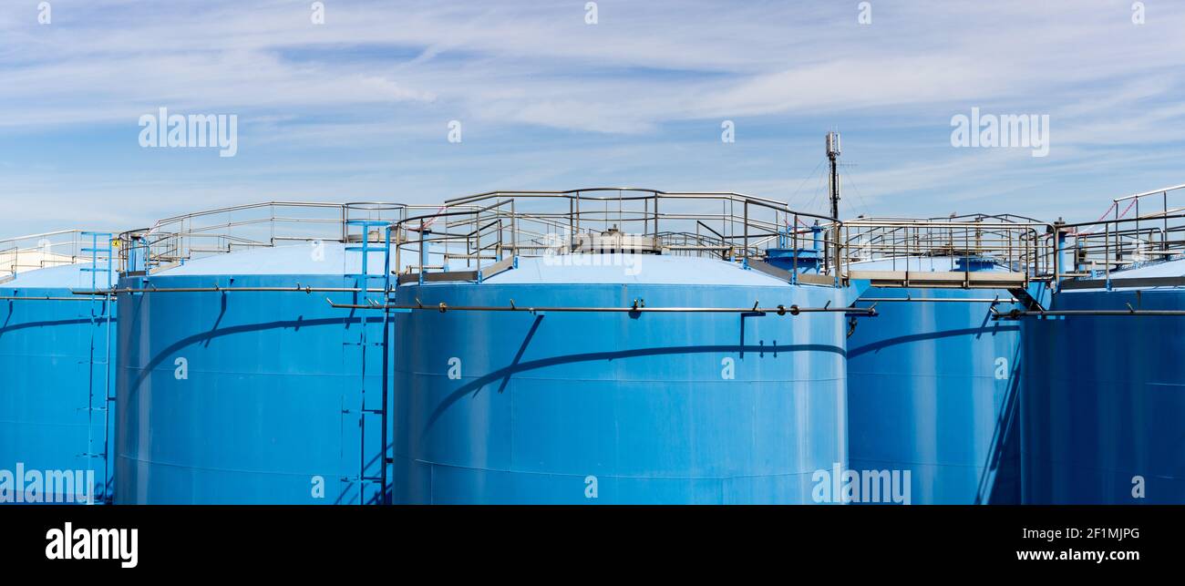 Large blue indsutrial silos or storage tanks for oil or other liquids Stock Photo