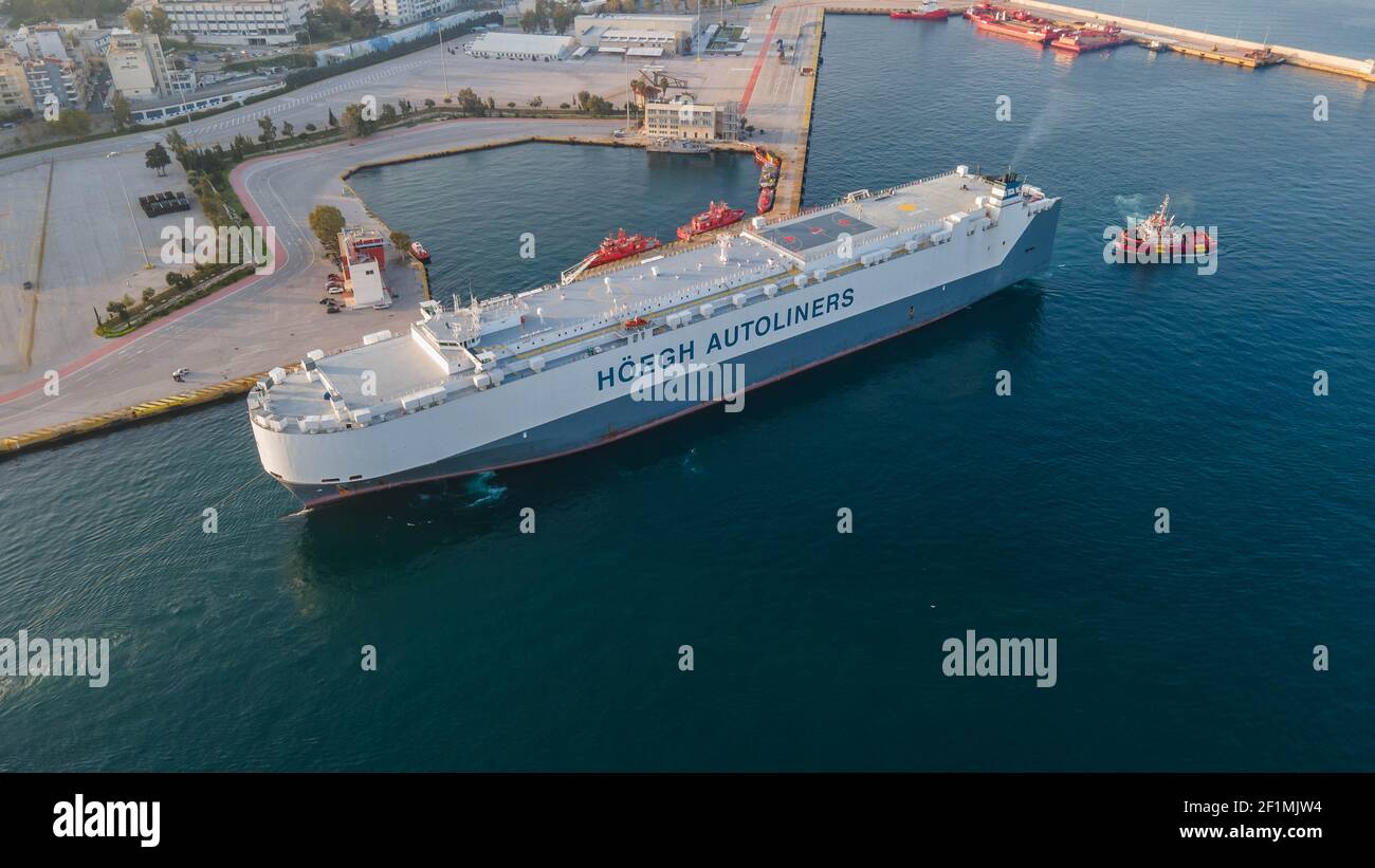 A big tanker being dragged in Piraeus port ,Greece Stock Photo - Alamy