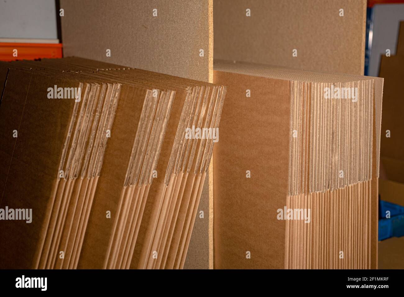 A selection of flat shipping boxes/cartons on a shelf ready to be made ...