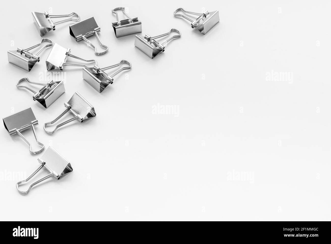 Paper binder clips. Stationery and office supplies background Stock