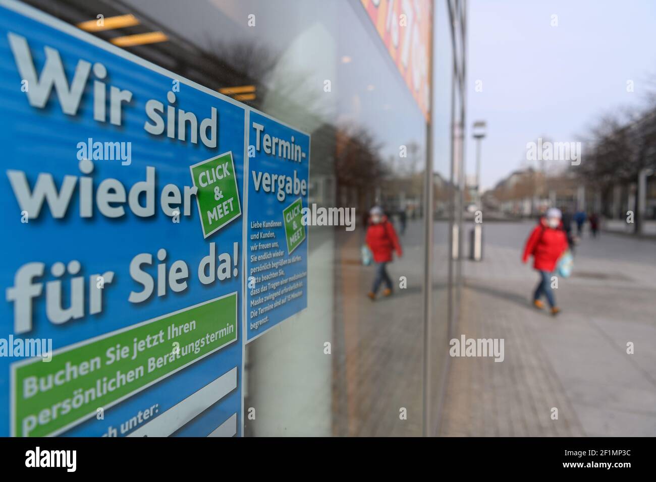 Dresden, Germany. 09th Mar, 2021. Notices 'We are here for you again' and 'Appointment allocation' for the so-called 'Click & Meet' hang on a shop window of a shoe store on Prager Straße. After a week-long corona-induced lockdown, many retailers are offering a new concept with 'Click & Meet', which makes shopping with an appointment possible from now on. Credit: Robert Michael/dpa-Zentralbild/dpa/Alamy Live News Stock Photo