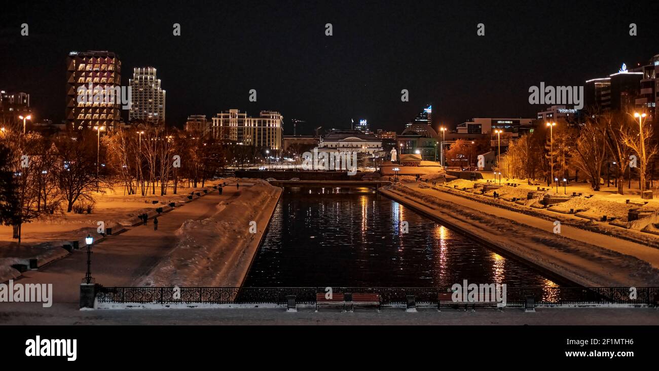 Night cityscape of winter Yekaterinburg, Russia. Iset river embankment ...