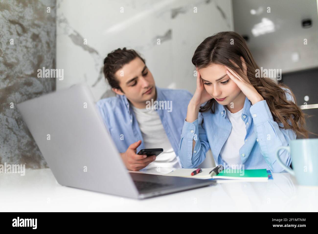 Family paying bills at kitchen table hires stock photography and