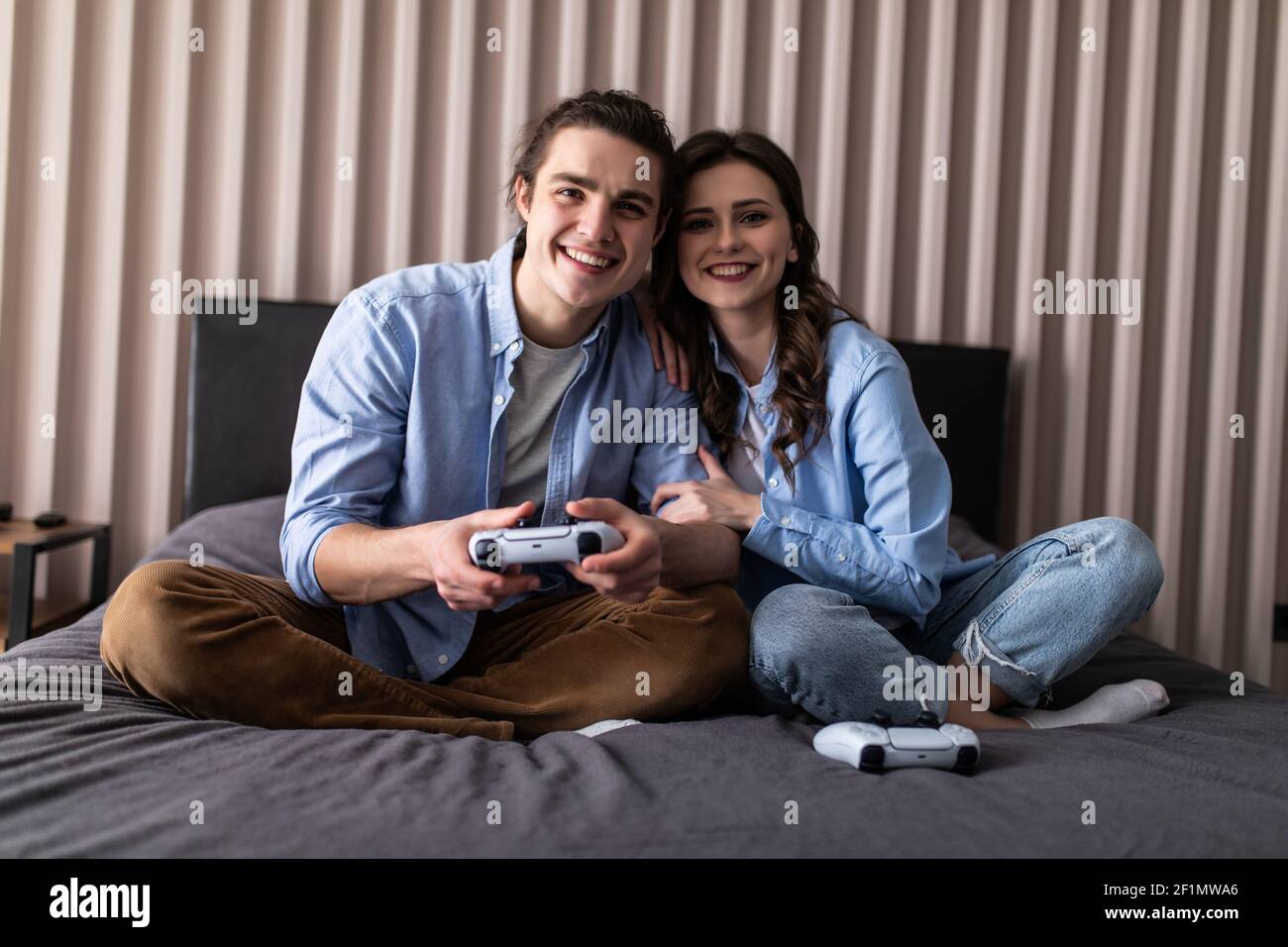 Cheerful couple play video game hi-res stock photography and images - Alamy