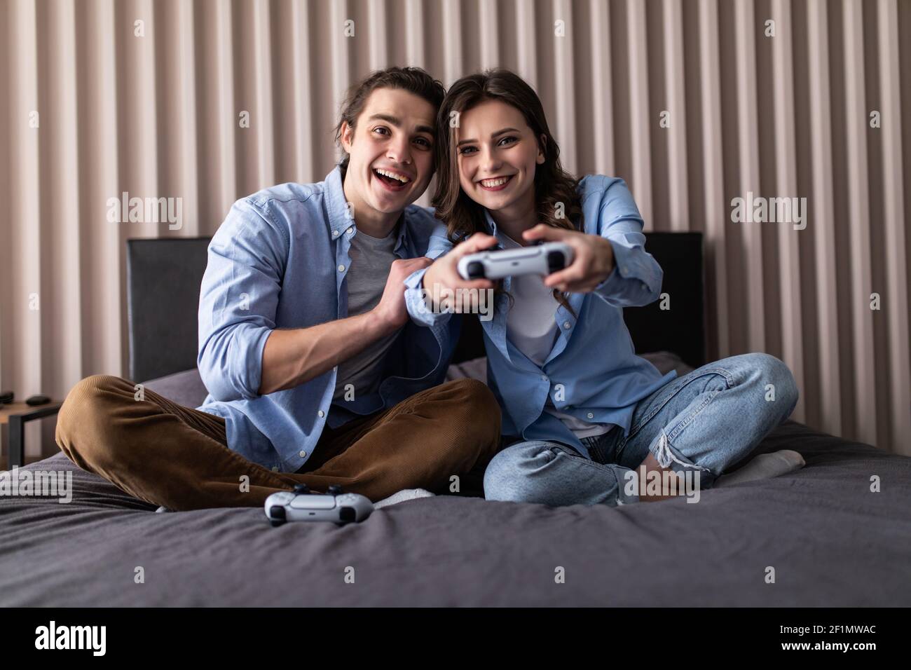 Cheerful couple play video game hi-res stock photography and images - Alamy