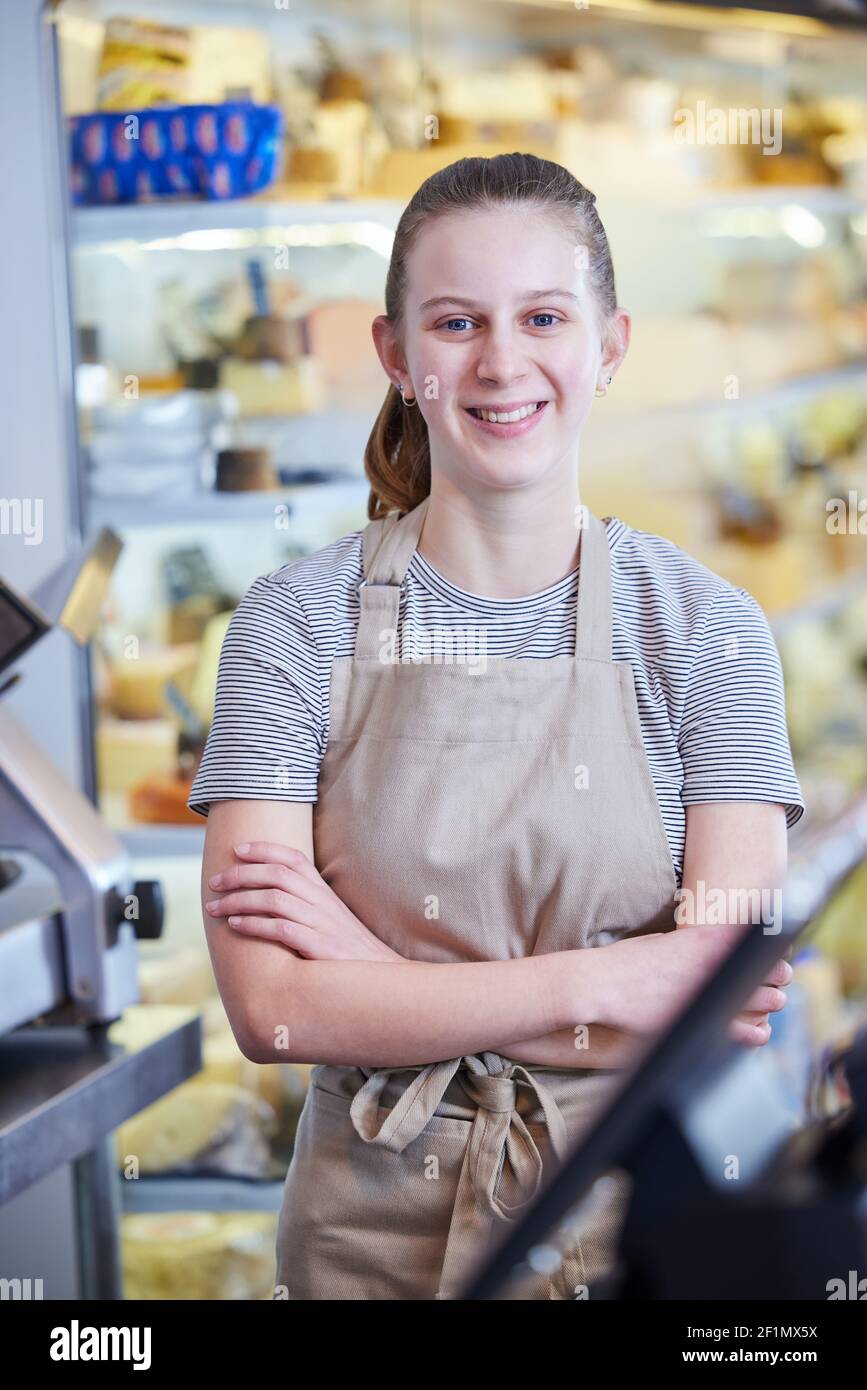 Portrait Ot Teenage Girl Working In Delicatessen Food Shop As Job Experience Stock Photo