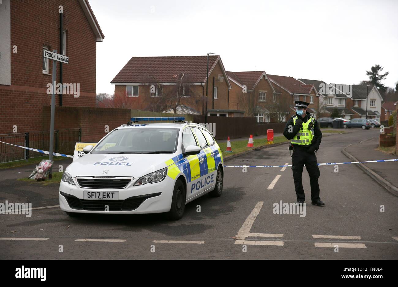 A police officer stands at the entrance to Troon Avenue in Dundee as
