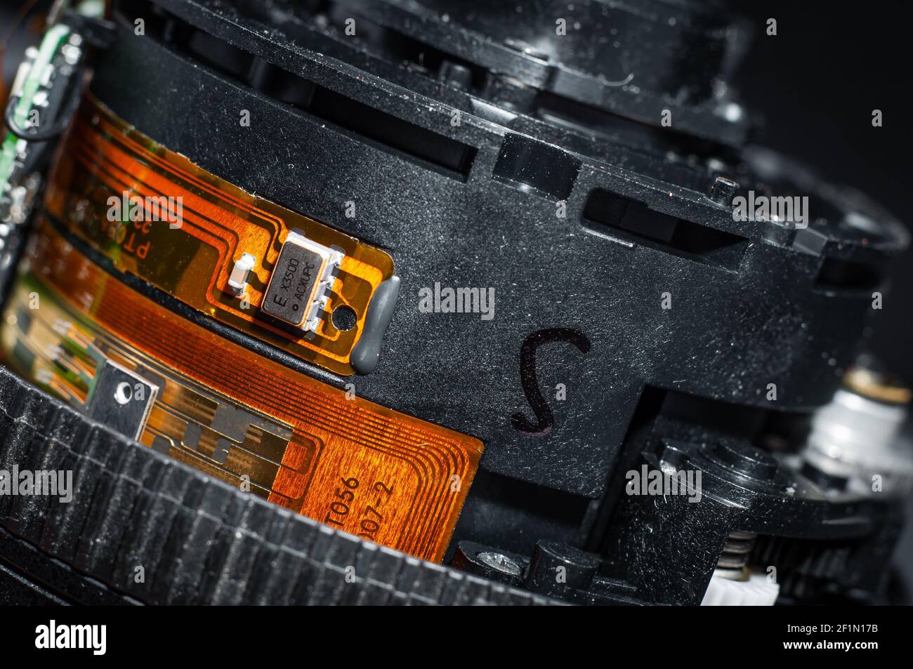 Microchip glued to the lens barrel. Repair and replacement of parts in photographic equipment Stock Photo