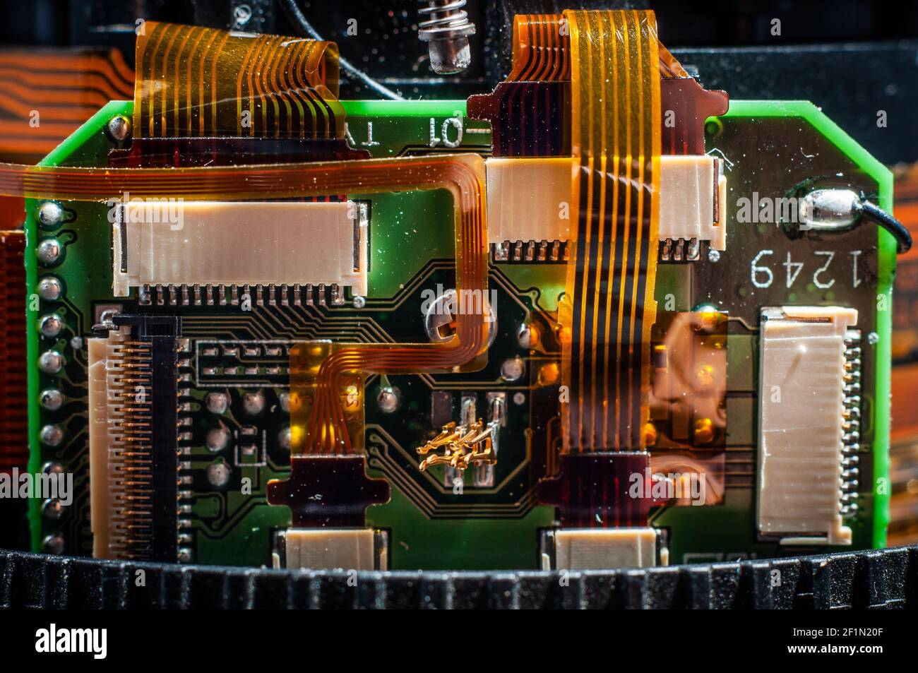 Board with a microchip and connected and a ribbon cable inside the lens close-up, macro photography Stock Photo