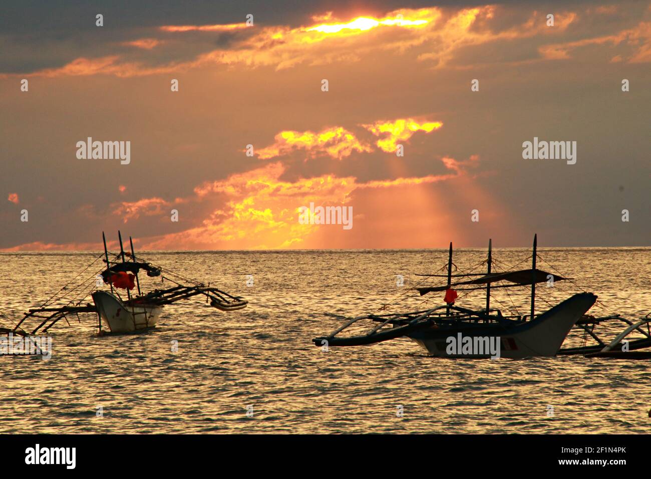 Two Traditional Fishing Boats with Cloudy Sunset Stock Photo