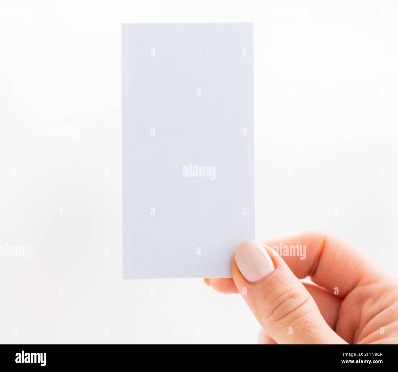 Hand holding empty white business card Stock Photo