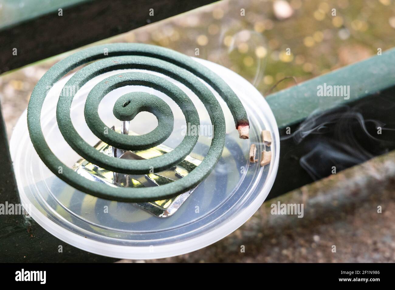Closeup on traditional mosquito repellent coil emit smoke to repel mosquito outdoor Stock Photo