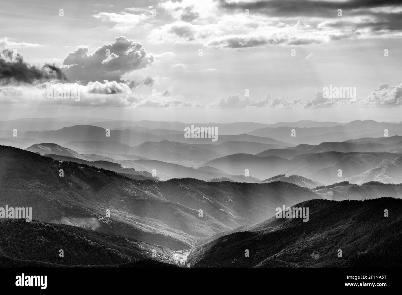 Mountain landscape with sun beams in ukrainian Carpathiaan in black and ...