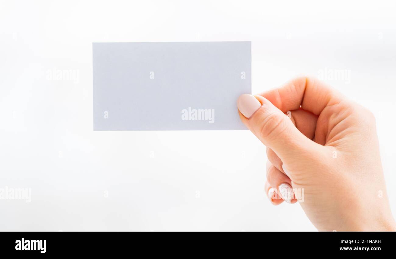 Hand holding empty white business card Stock Photo