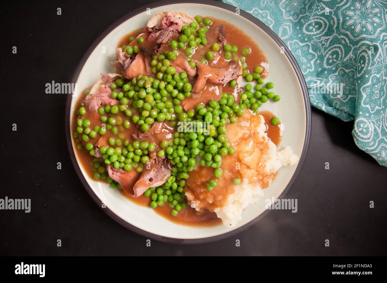 open faced hot roast beef sandwich with mashed and gravy and peas Stock Photo Alamy