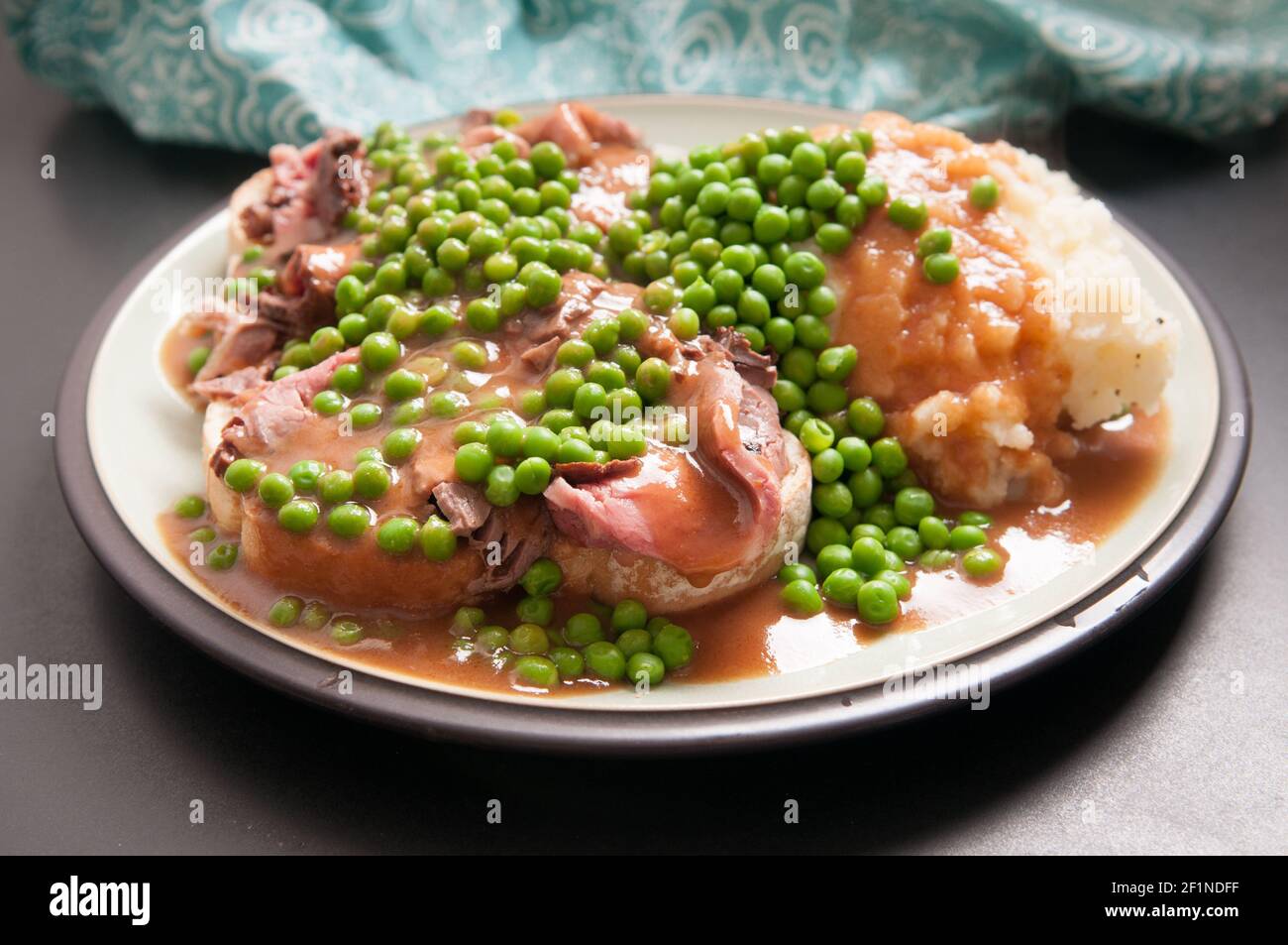 open faced hot roast beef sandwich with mashed and gravy and peas Stock Photo Alamy