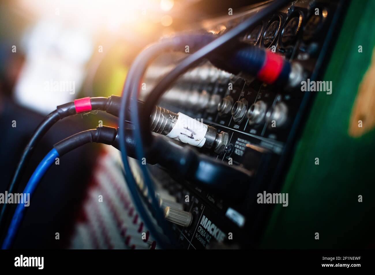 Closeup of colorful cables connected to a guitar amplifier inside a