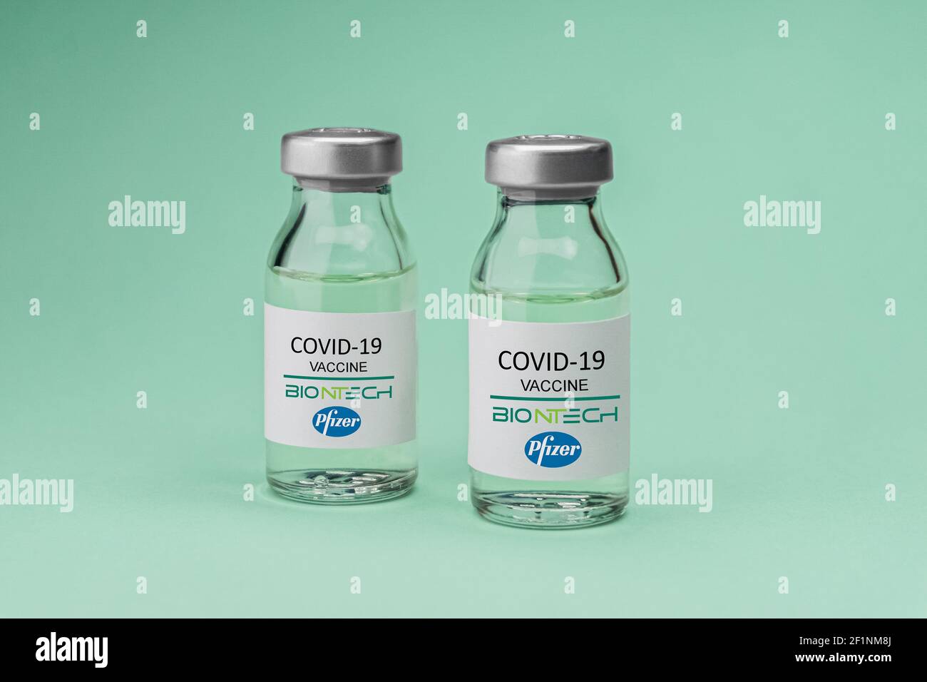 Izmir, Turkey - November 18 2020: Coronavirus vaccine concept and background. New vaccine pfizer and biontech isolated on green background. Covid-19, Stock Photo