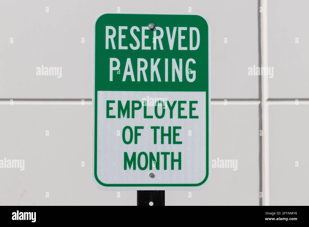 Reserved Parking for the Employee of the Month sign in white and green text. Stock Photo