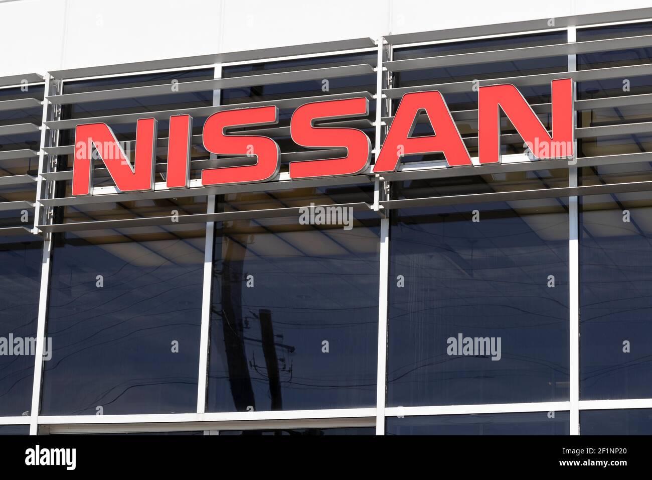 Indianapolis - Circa March 2021: Logo and Signage of a Nissan Car and SUV Dealership. Nissan is part of the Renault–Nissan Alliance. Stock Photo