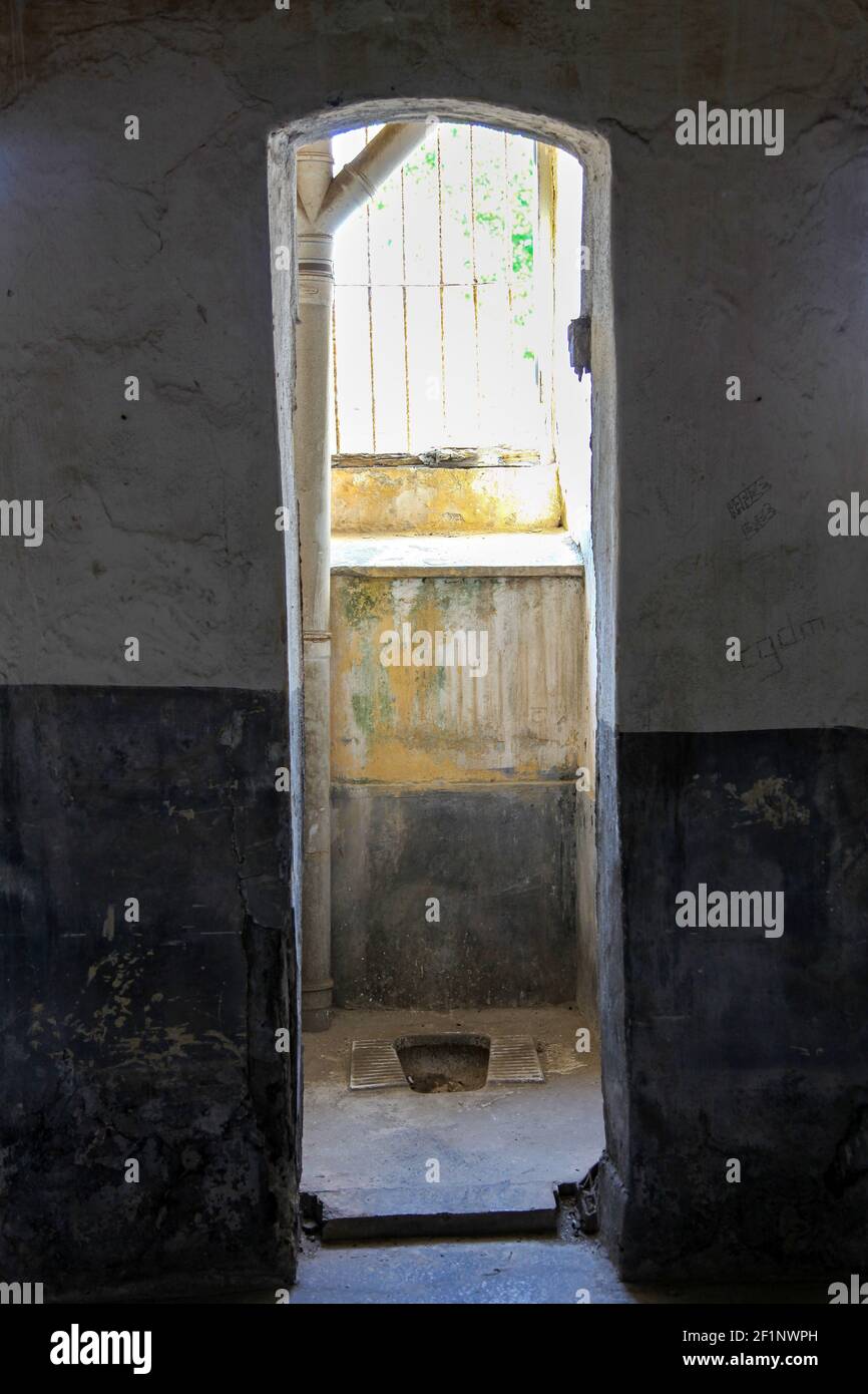 Entrance door to an old style toilet in a prison. Stock Photo