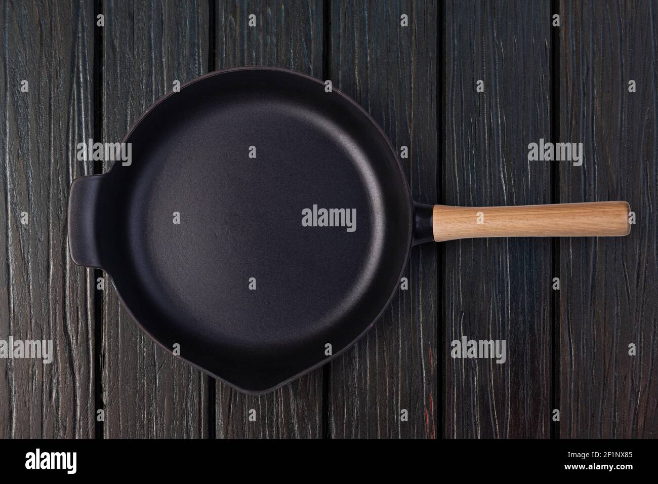 Empty frying pan on wooden background Stock Photo