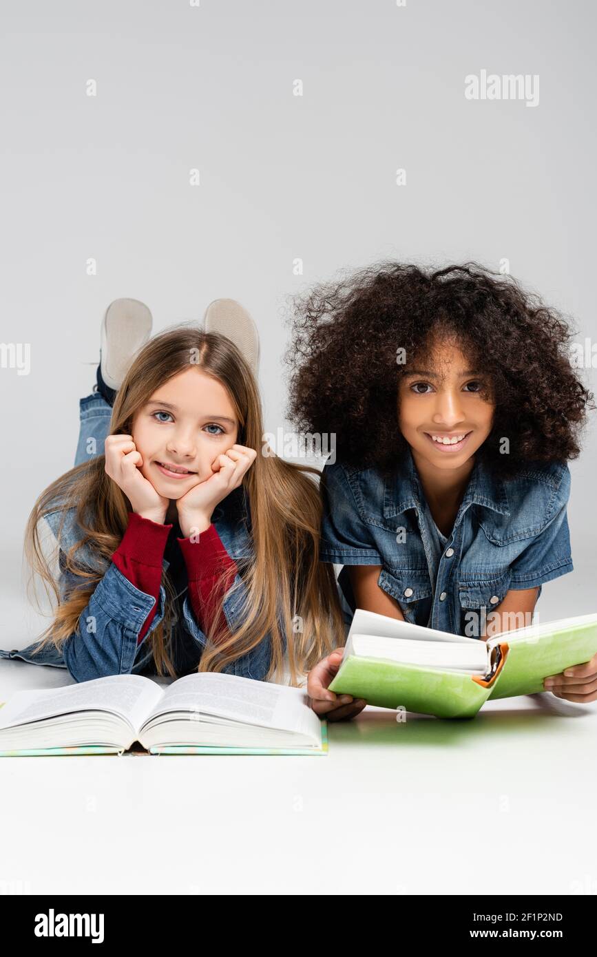 Black girl lying on books hi-res stock photography and images - Alamy