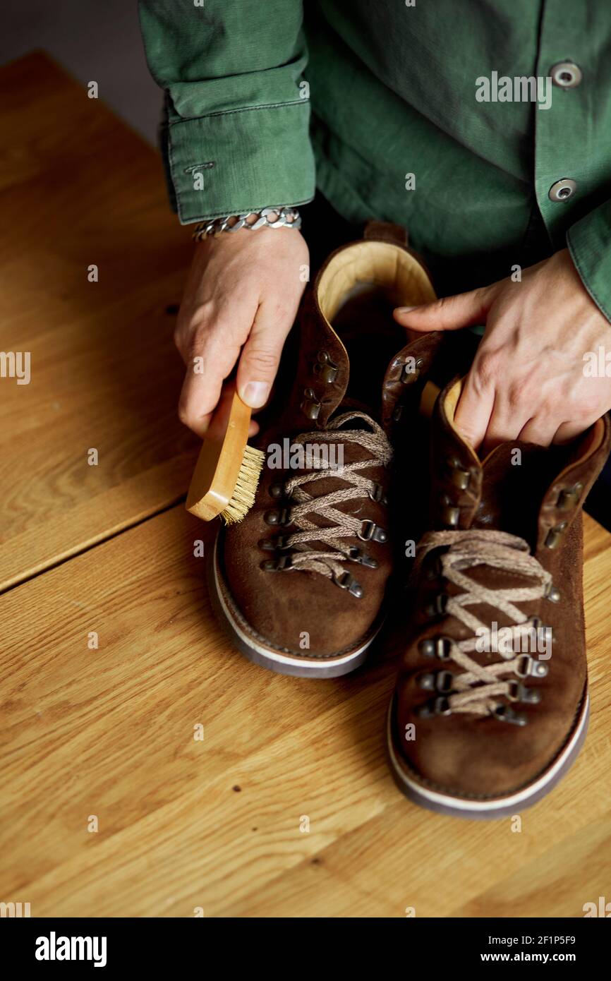 Applying a water-repellent hydrophobic spray to white women's sneakers.  Protection of shoes from moisture, dirt and unpleasant odor Stock Photo -  Alamy