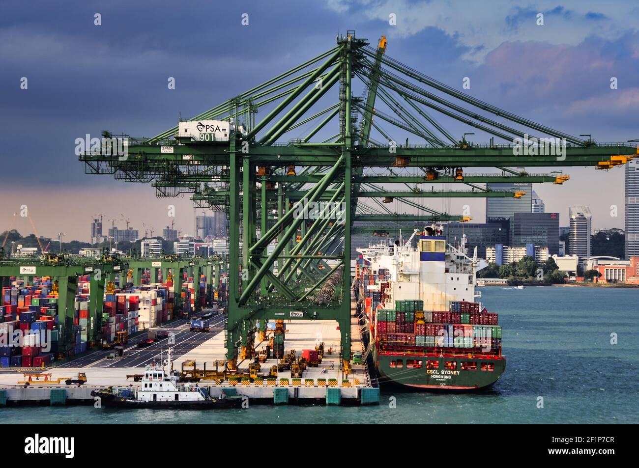 SINGAPORE, SINGAPORE - Apr 16, 2019: Picture taken when passing by container port Singapore with a cruise ship. Shows loading cranes rowed up loading Stock Photo