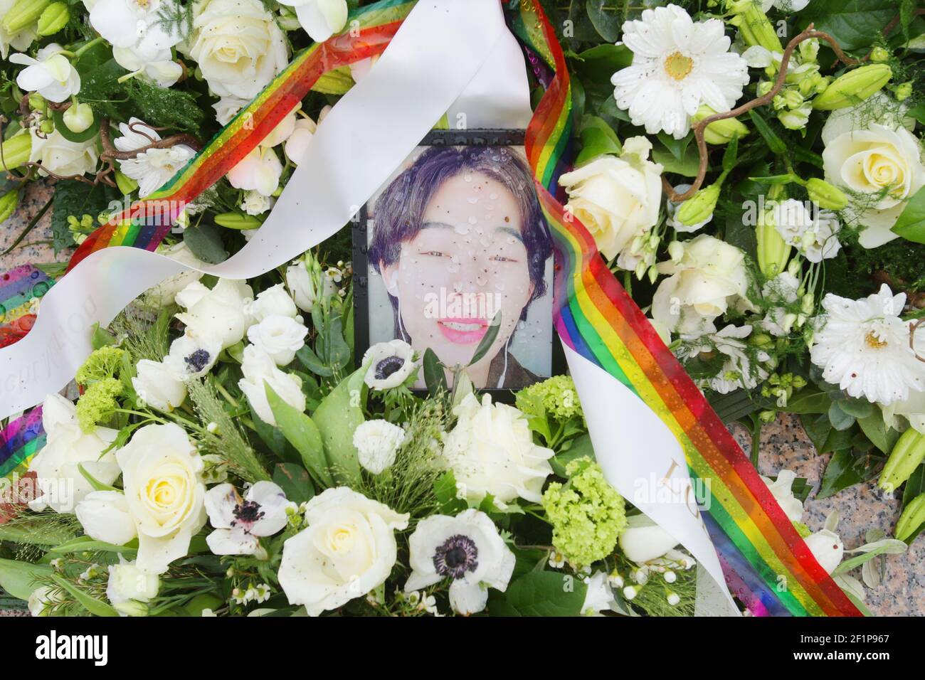 A picture of the activist Xingshun Zhou and flowers placed in memory by LGBT Asylum Support at the Homomonument on March 9, 2021 in Amsterdam, Netherlands. Xingshun Zhou (Marlon) an Chinese activist transwoman 23-year old forced to move from China to seek asylum in the Netherlands, because of the systematic homophobic and sexist repression against LGBTQIA  Community, died by suicide on February 26, 2021 at Echt village after her asylum application was denied by immigration authorities in the Netherlands. (Photo by Paulo Amorim/Sipa USA) Stock Photo