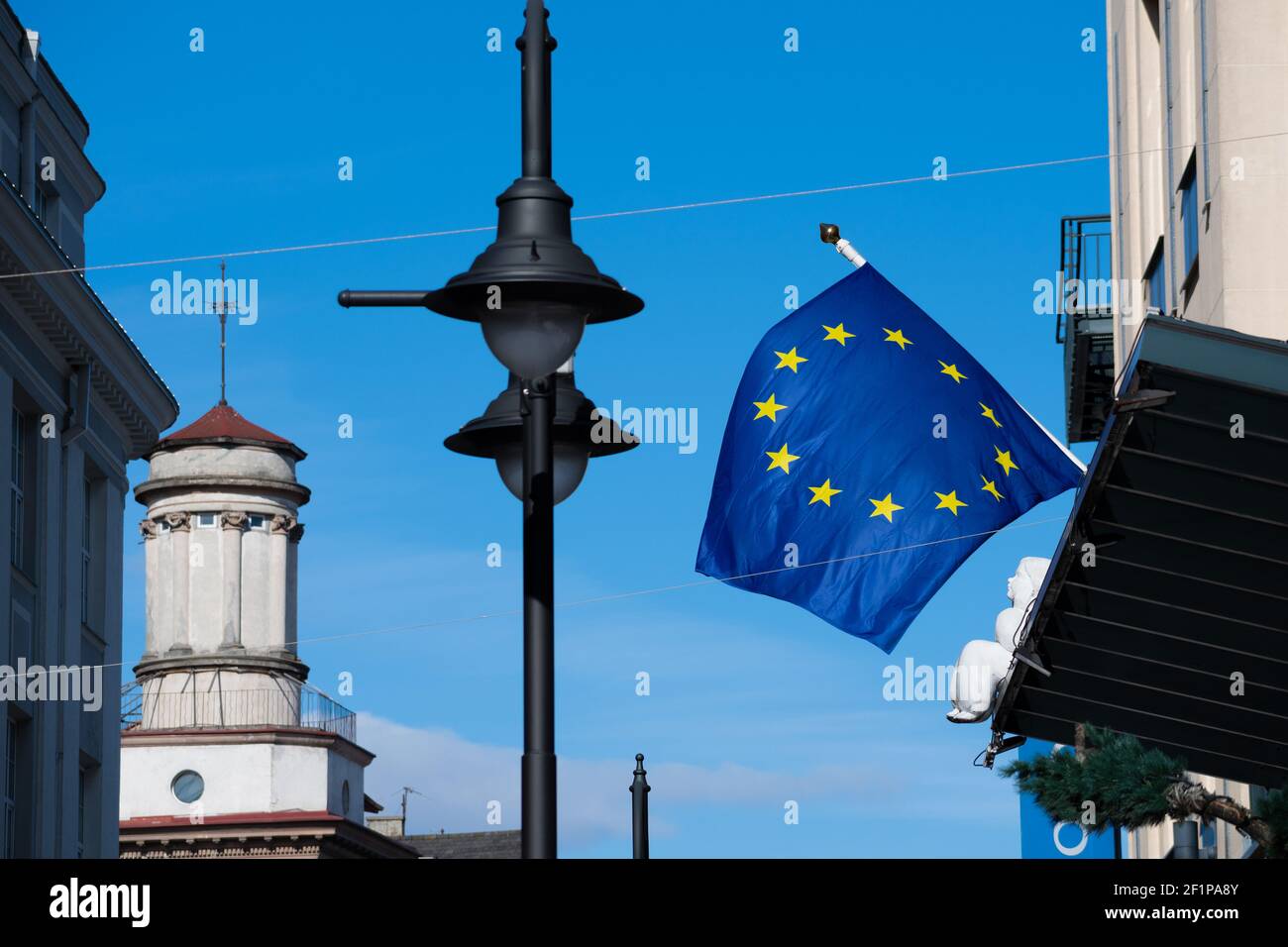 Europe or European Union flag waving, blown by an angel on the roofs of houses Stock Photo