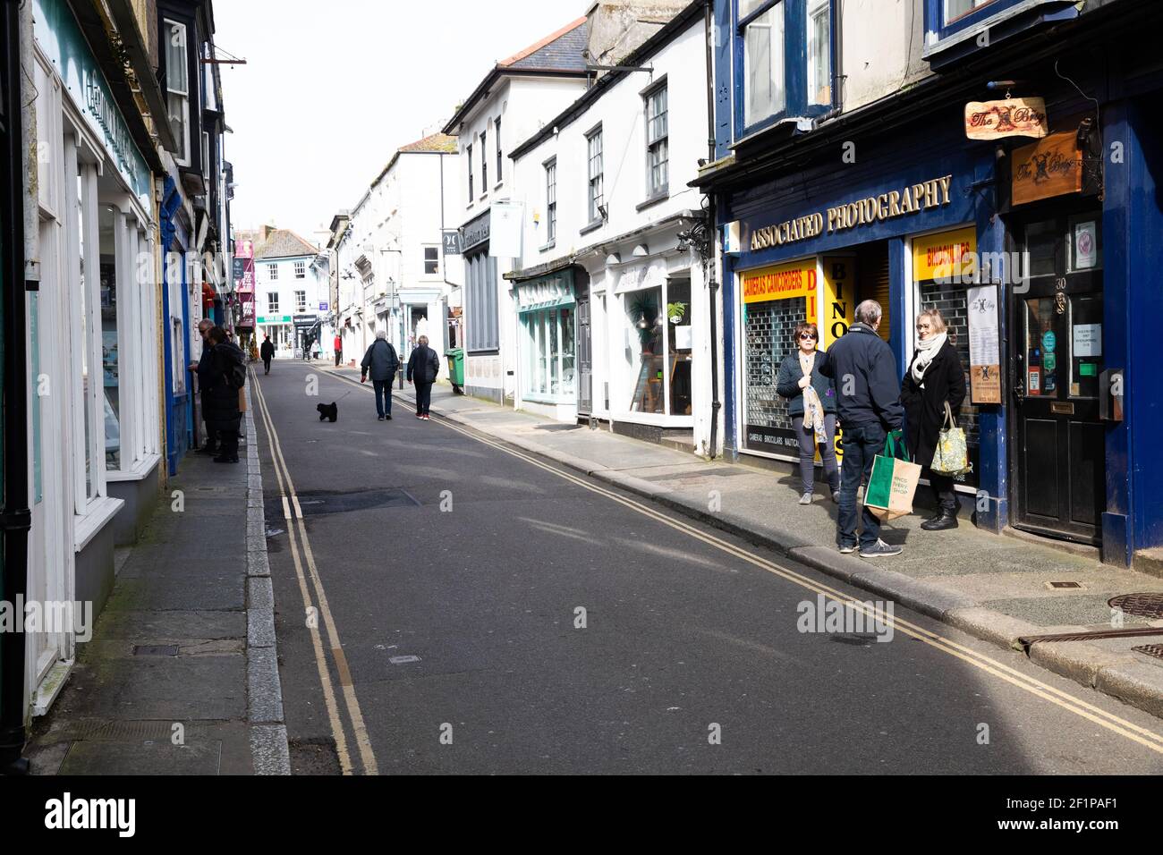 Falmouth,Cornwall,UK,9th March 2021,Deserted Falmouth during Lockdown. Non essential Shops remain closed but people are allowed to meet one other person outdoors so people were sitting on benches on the harbour front making the most of the Boris’ new road map .Credit Keith Larby/Alamy Live News Stock Photo
