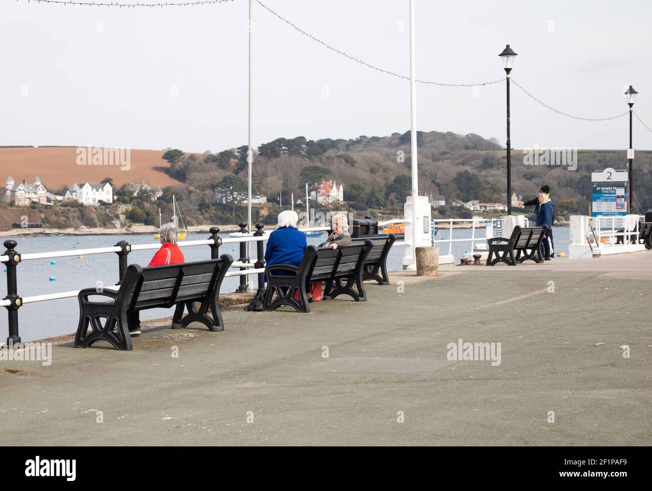 Falmouth,Cornwall,UK,9th March 2021,Deserted Falmouth during Lockdown. Non essential Shops remain closed but people are allowed to meet one other person outdoors so people were sitting on benches on the harbour front making the most of the Boris’ new road map .Credit Keith Larby/Alamy Live News Stock Photo
