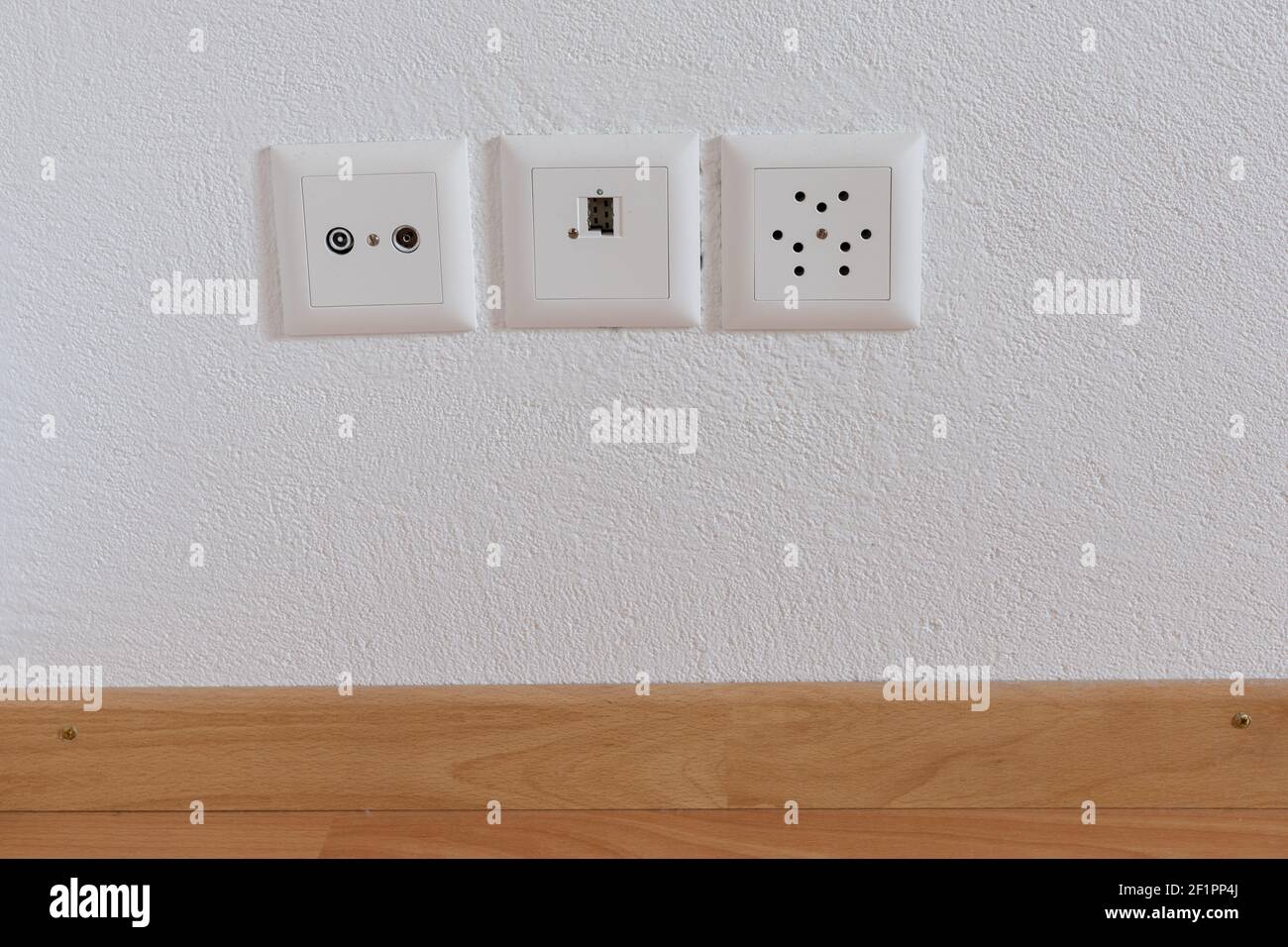 Close up view of sockets for television, internet, telephone and electricity on a white wall Stock Photo