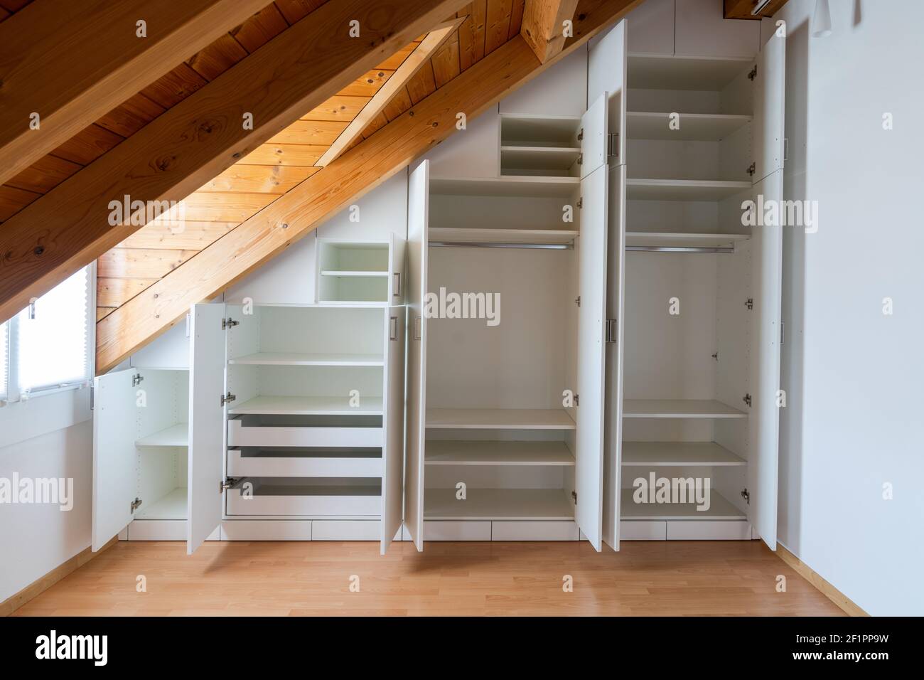 Interior view of a custom-made closet with open doors built into a ...