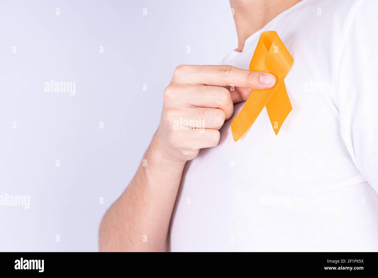 World kidney day, hands holding orange ribbon awareness of kidney