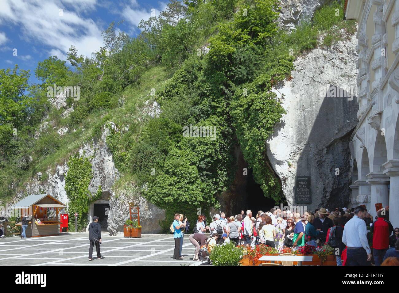 Postojna, Slovenia - Jun 26, 2011: Square and tourists at entrance to cave 'Postojnska jama' Stock Photo