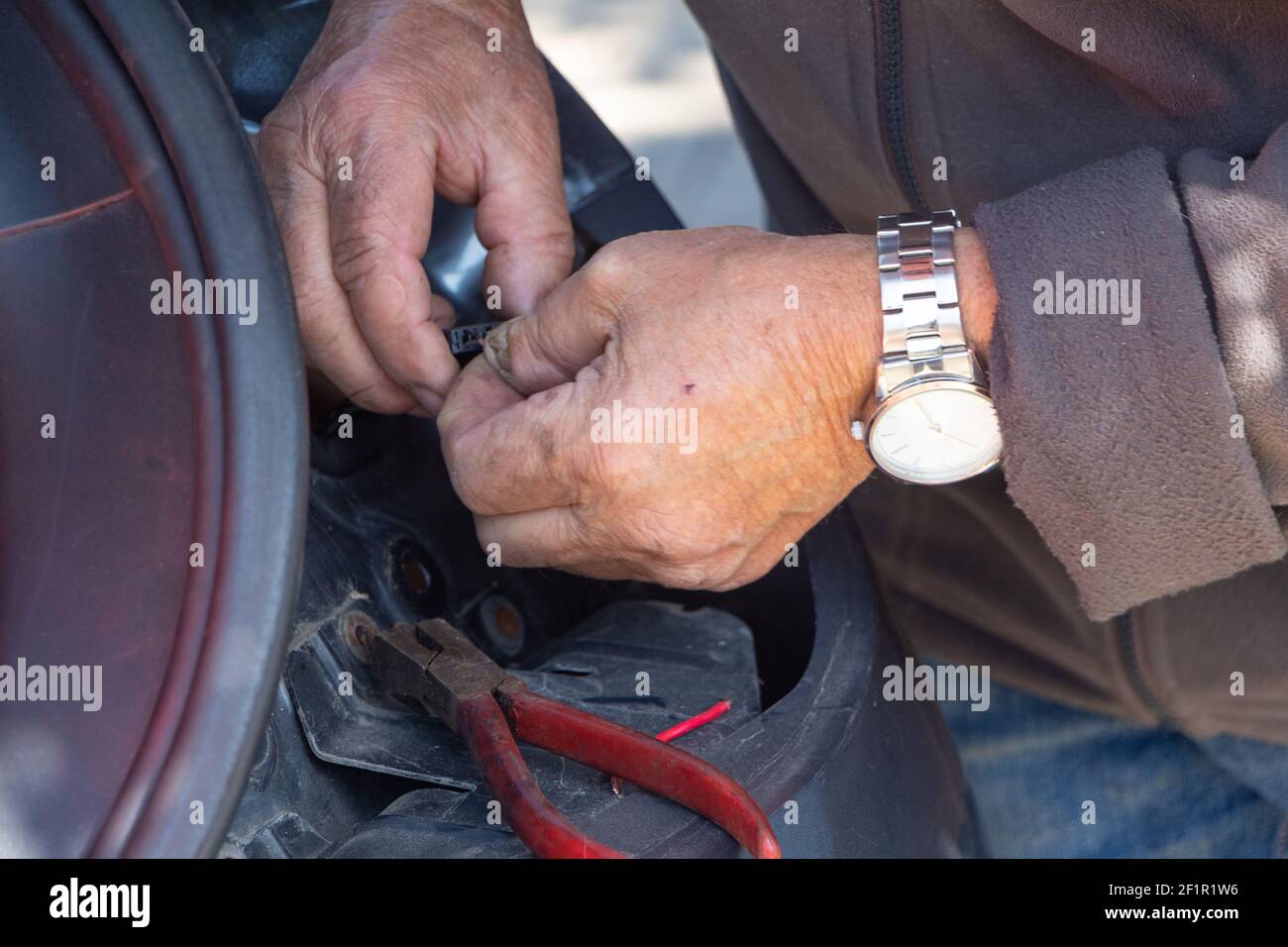 Mechanic repairing a car backlight in a backyard Stock Photo Alamy