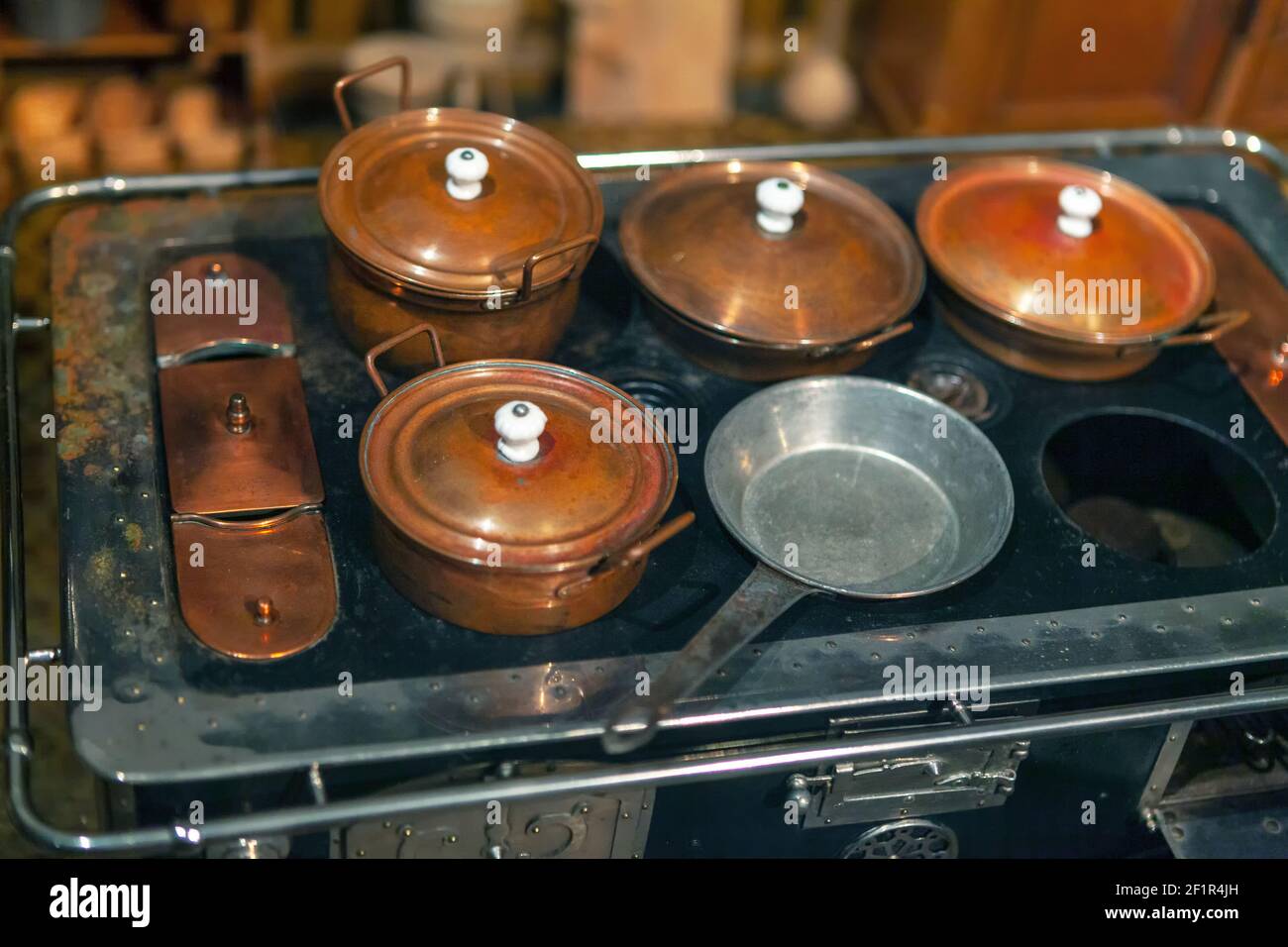 Copper pots on a stove . Miniature kitchen layout Stock Photo Alamy