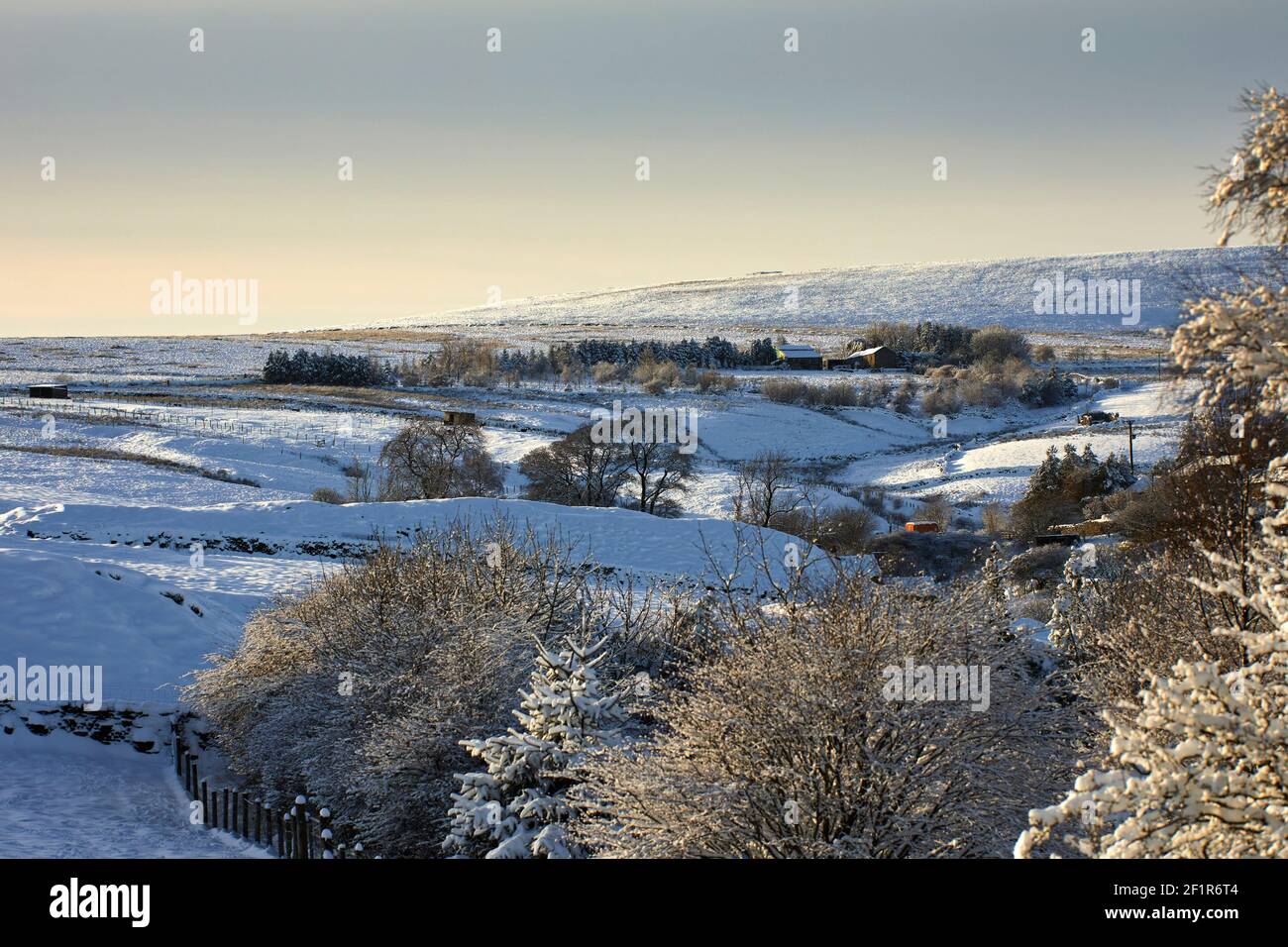 Farmland and homes and a snowy view in the Yorkshire Dales at 900ft Stock Photo