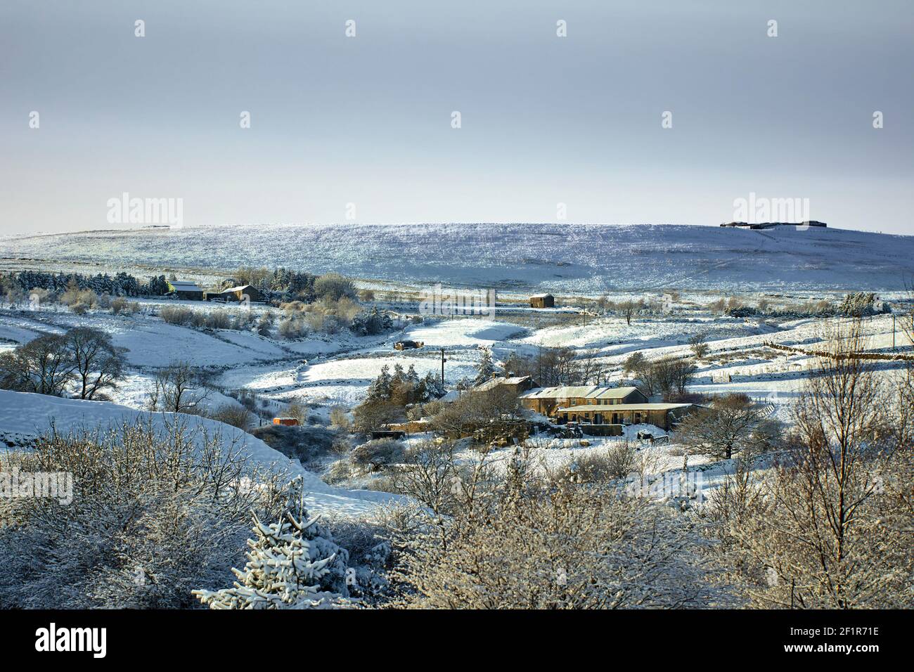 Farmland and homes and a snowy view in the Yorkshire Dales at 900ft Stock Photo