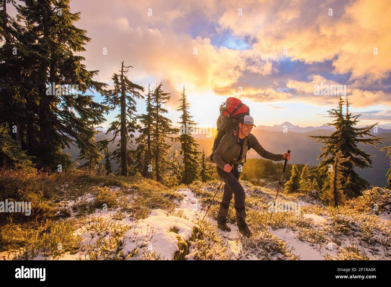 Backpacker enjoy the mountain view during sunet. Stock Photo